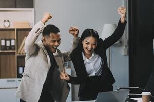 Two happy friendly diverse professionals, teacher and student giving high five standing in office celebrating success, good cooperation result, partnership teamwork and team motivation in office work. photo