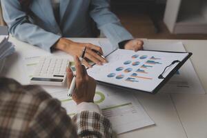Team of business people working together in the meeting room office, teamwork background charts and graphs banner, double exposure successful teamwork,business planning concept. photo
