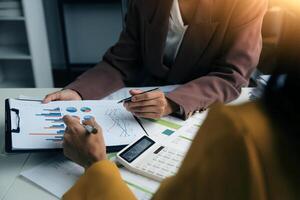 Team of business people working together in the meeting room office, teamwork background charts and graphs banner, double exposure successful teamwork,business planning concept. photo