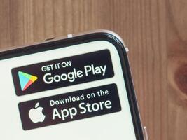 Google Play and App Store icons on infinity display smartphone photo