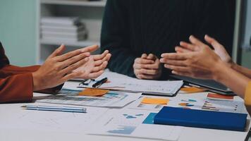 A group of cheerful Asian graphic designers or developers is standing in the meeting, clapping their hands, and celebrating their successful project in the meeting together. video