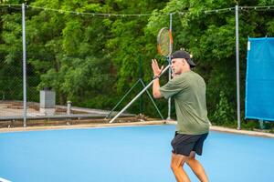 Professional male tennis player playing the tennis on outside court. High quality photo