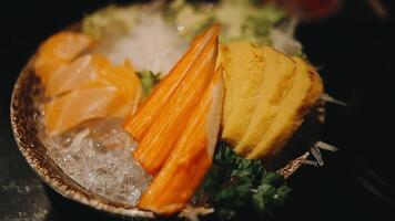 Japanese food set. Raw fish packed in a red, round object. The set consists of salmon, tuna, crab sticks, sweet egg. video