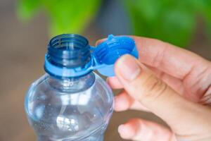 Stationary plastic cap on a PET bottle. The new design means the cap remains attached to the bottle after opening, making the entire package easier to collect and recycle. High quality photo