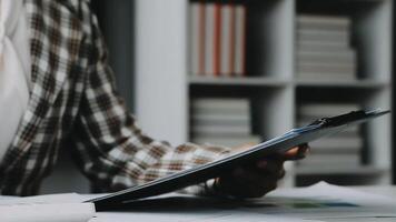 Financial analysts analyze business financial reports on a digital tablet planning investment project during a discussion at a meeting of corporate showing the results of their successful teamwork. video