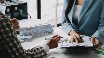 Financial analysts analyze business financial reports on a digital tablet planning investment project during a discussion at a meeting of corporate showing the results of their successful teamwork. video