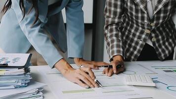 Close up Business woman using calculator and laptop for do math finance on wooden desk in office and business working background, tax, accounting, statistics and analytic research concept video