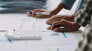 Close up Business woman using calculator and laptop for do math finance on wooden desk in office and business working background, tax, accounting, statistics and analytic research concept video