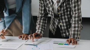 Close up Business woman using calculator and laptop for do math finance on wooden desk in office and business working background, tax, accounting, statistics and analytic research concept video