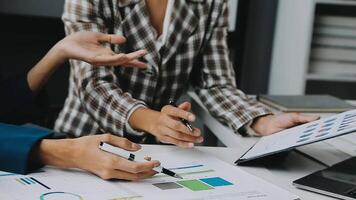 Financial analysts analyze business financial reports on a digital tablet planning investment project during a discussion at a meeting of corporate showing the results of their successful teamwork. video