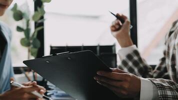 Financial analysts analyze business financial reports on a digital tablet planning investment project during a discussion at a meeting of corporate showing the results of their successful teamwork. video