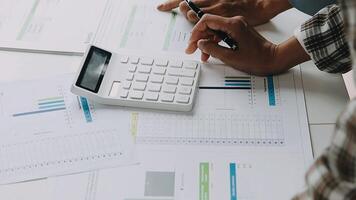Close up Business woman using calculator and laptop for do math finance on wooden desk in office and business working background, tax, accounting, statistics and analytic research concept video