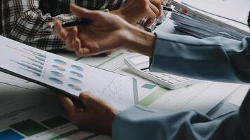 Financial analysts analyze business financial reports on a digital tablet planning investment project during a discussion at a meeting of corporate showing the results of their successful teamwork. video