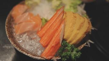 Japanese food set. Raw fish packed in a red, round object. The set consists of salmon, tuna, crab sticks, sweet egg. video