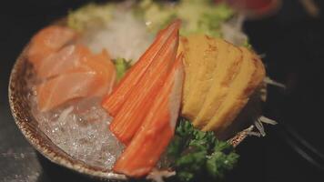 Japanese food set. Raw fish packed in a red, round object. The set consists of salmon, tuna, crab sticks, sweet egg. video