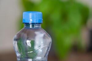 Stationary plastic cap on a PET bottle. The new design means the cap remains attached to the bottle after opening, making the entire package easier to collect and recycle. High quality photo