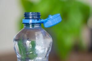 Stationary plastic cap on a PET bottle. The new design means the cap remains attached to the bottle after opening, making the entire package easier to collect and recycle. High quality photo