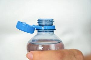 Stationary plastic cap on a PET bottle. The new design means the cap remains attached to the bottle after opening, making the entire package easier to collect and recycle. High quality photo