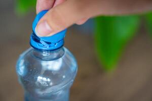 Stationary plastic cap on a PET bottle. The new design means the cap remains attached to the bottle after opening, making the entire package easier to collect and recycle. High quality photo