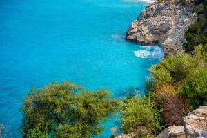 Aerial view of Oludeniz beach with people and boats in the morning, Coastline next to Fethiye, Turkey. High quality photo