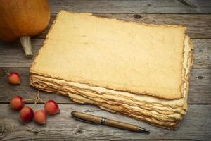stack of blank handmade paper with rough edges photo