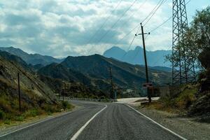View from the car of an asphalt road in the mountainous area of Dagestan photo