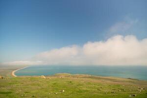 A beautiful blue ocean with a cloudy sky in the background. photo