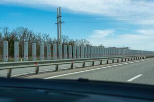 A road with a long line of metal posts with red hearts on them photo