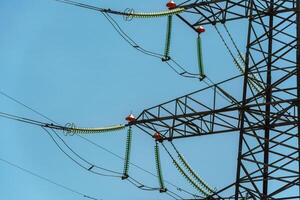 High voltage towers with sky background. Power line support with wires for electricity transmission. High voltage grid tower with wire cable at distribution station. Energy industry, energy saving photo