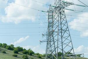 High voltage towers with sky background. Power line support with wires for electricity transmission. High voltage grid tower with wire cable at distribution station. Energy industry, energy saving photo