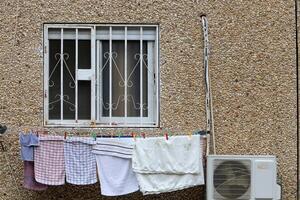 Washed laundry hangs on a rope outside the window. photo