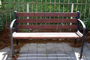 A bench for relaxing in a city park on the seashore. photo
