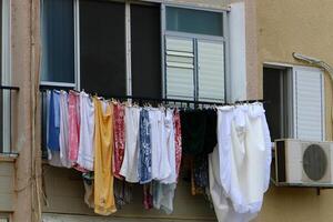 Washed laundry hangs on a rope outside the window. photo