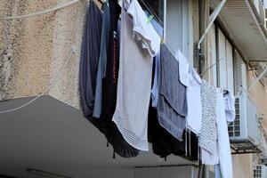 Washed laundry hangs on a rope outside the window. photo