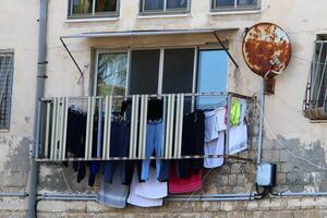 Washed laundry hangs on a rope outside the window. photo