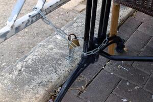 An old metal lock hangs on the fence. photo