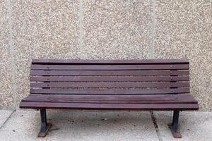 A bench for relaxing in a city park on the seashore. photo