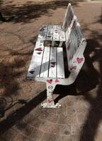 A bench for relaxing in a city park on the seashore. photo