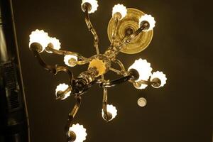 A lamp for illuminating the interior of the room hangs on the ceiling. photo