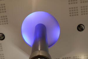 A lamp for illuminating the interior of the room hangs on the ceiling. photo