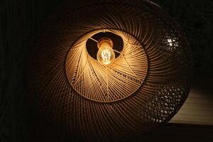 A lamp for illuminating the interior of the room hangs on the ceiling. photo