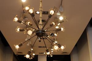 A lamp for illuminating the interior of the room hangs on the ceiling. photo