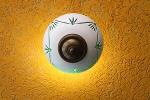 A lamp for illuminating the interior of the room hangs on the ceiling. photo