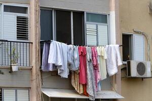 Washed laundry hangs on a rope outside the window. photo