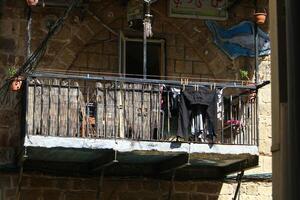 Washed laundry hangs on a rope outside the window. photo