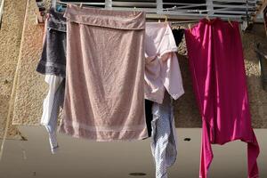 Washed laundry hangs on a rope outside the window. photo