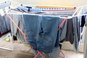 Washed laundry hangs on a rope outside the window. photo