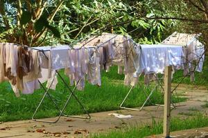 Washed laundry hangs on a rope outside the window. photo
