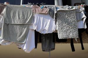 Washed laundry hangs on a rope outside the window. photo
