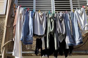 Washed laundry hangs on a rope outside the window. photo